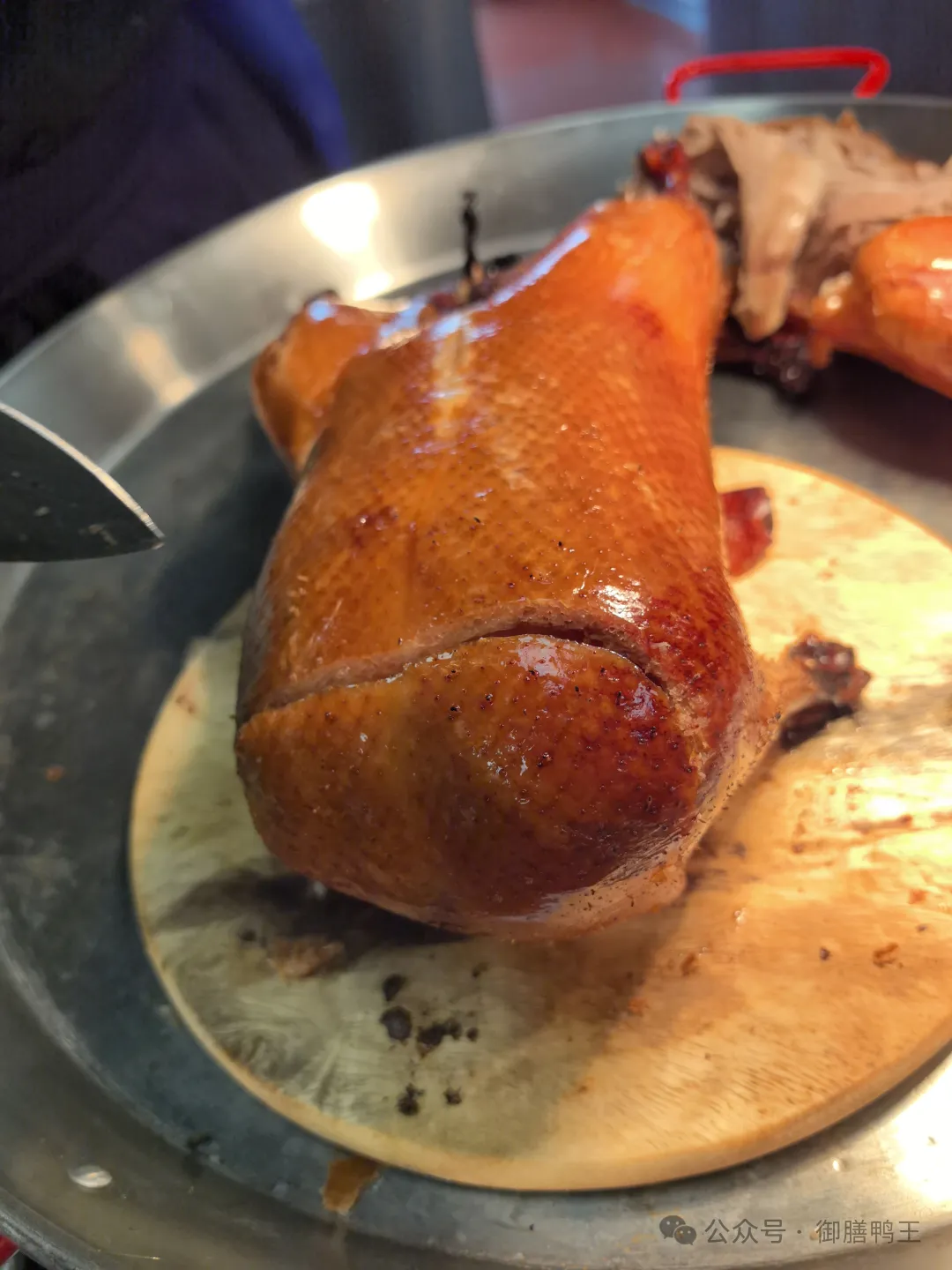 Finished roast duck leg with glossy crackling skin.